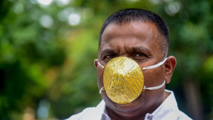 Indian man wears gold face mask to avoid coronavirus